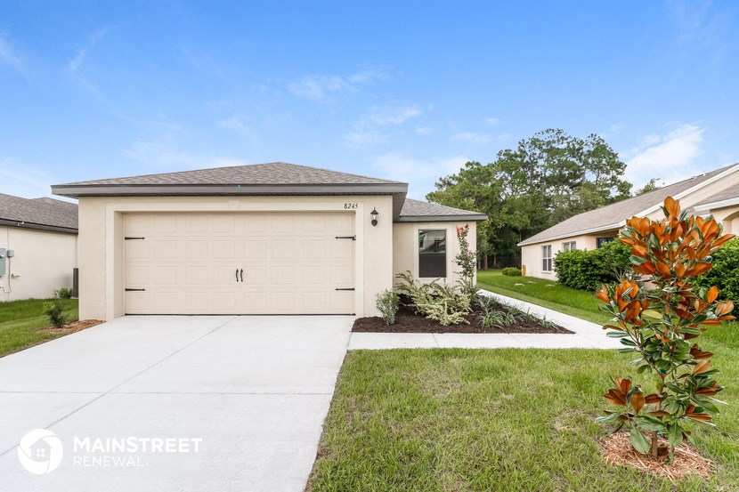 a white house with a garage and a driveway