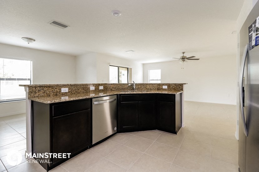 a kitchen with granite counter tops and stainless steel appliances