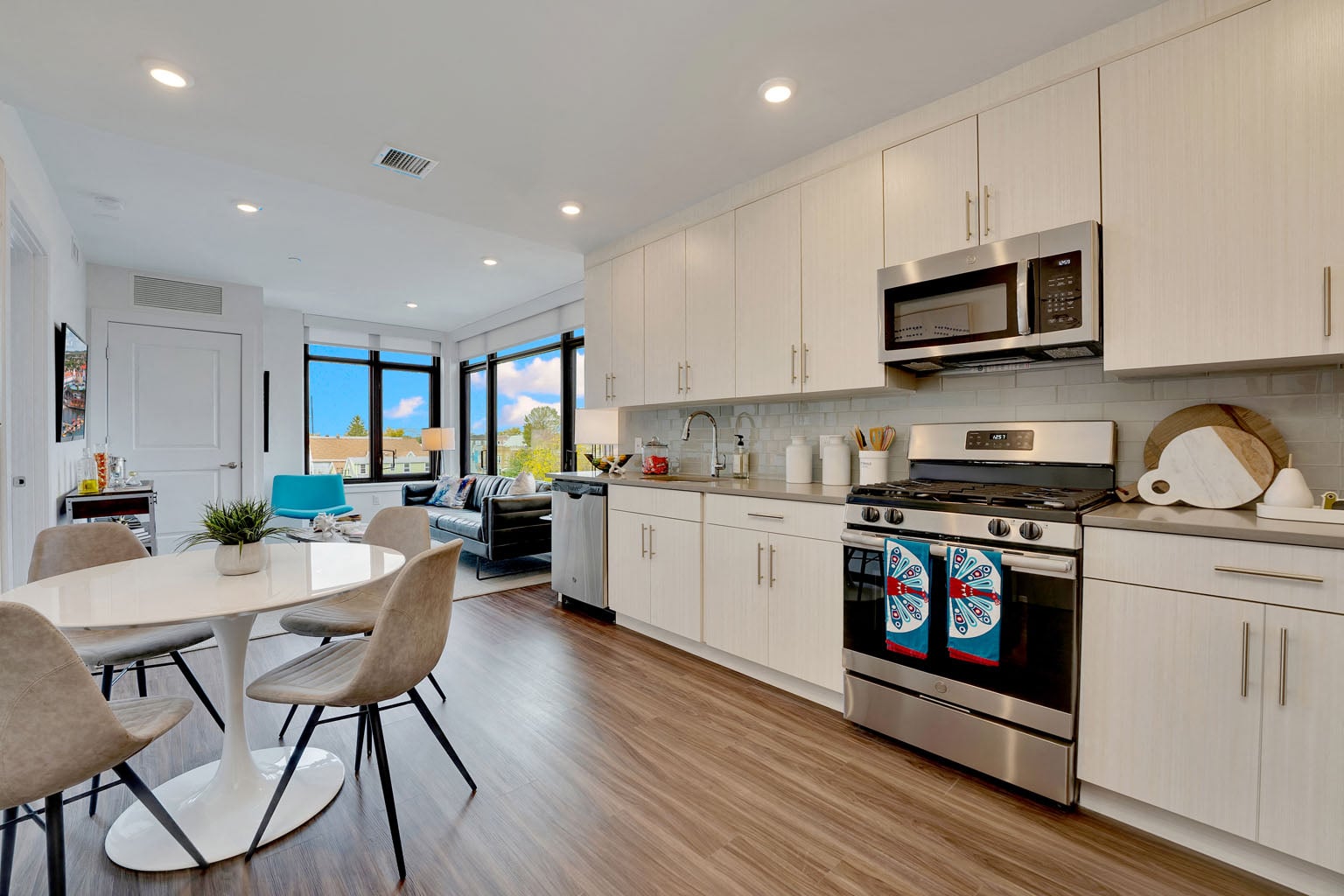 A modern kitchen with a dining table and chairs.
