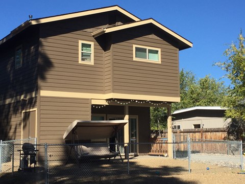 a home with a fenced in yard and a fence