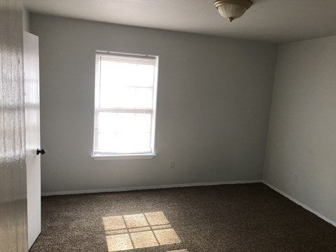 A room with a window and a door.