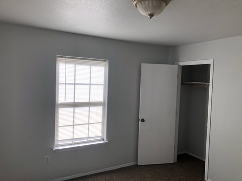 A room with a window and a door.