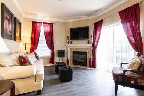 a living room with red curtains and a fireplace