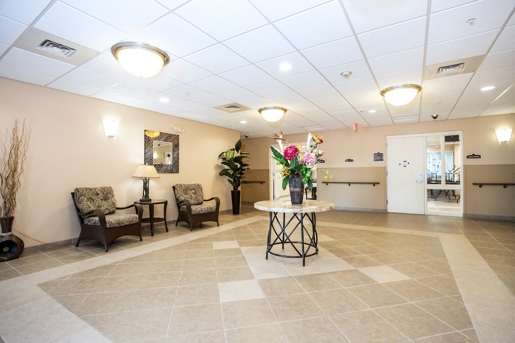 lobby with tile flooring, seating, and mailboxes