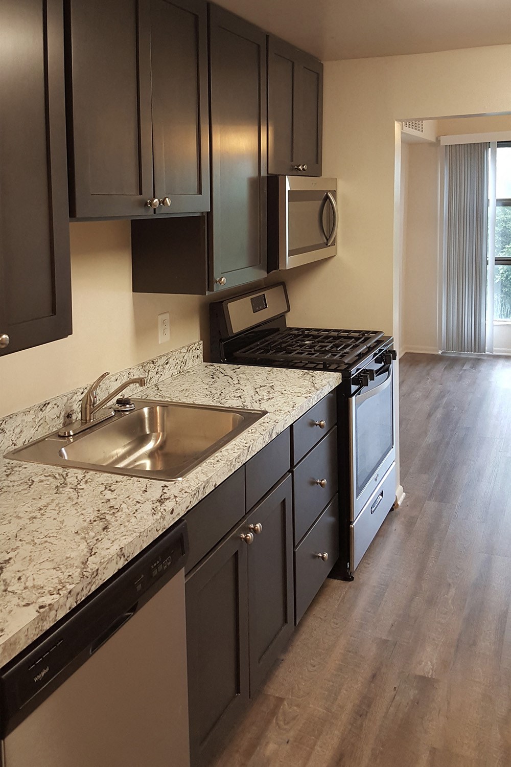 a kitchen with granite counter tops and stainless steel appliances
