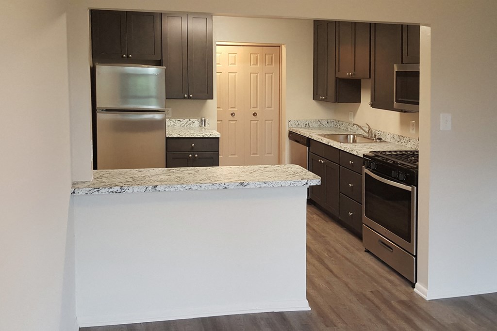 a kitchen with an island and stainless steel appliances