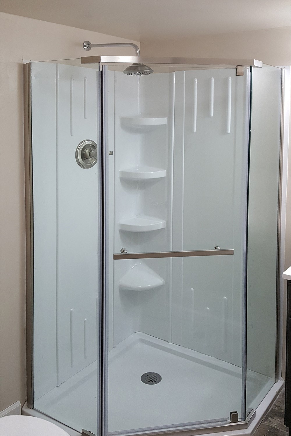 a shower with a glass door in a bathroom