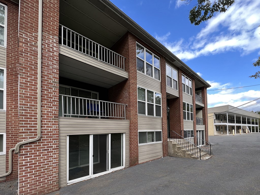 an exterior view of a brick apartment building with stairs and balconies