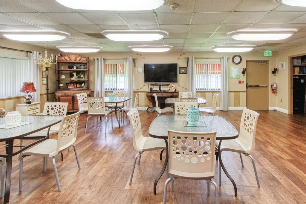 Community room with long tables and chairs at Casa San Pablo