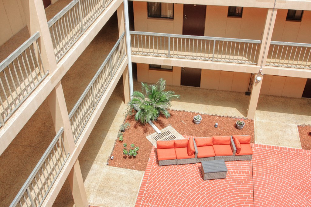 balconies looking into courtyard patio with swings and plants