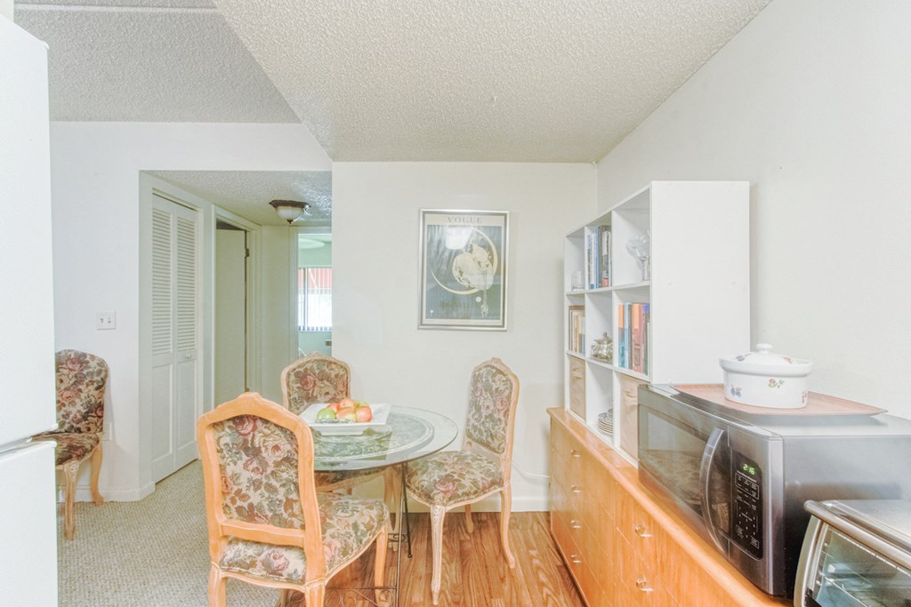 dining area with cabinetry, dining table and chairs, and small appliances