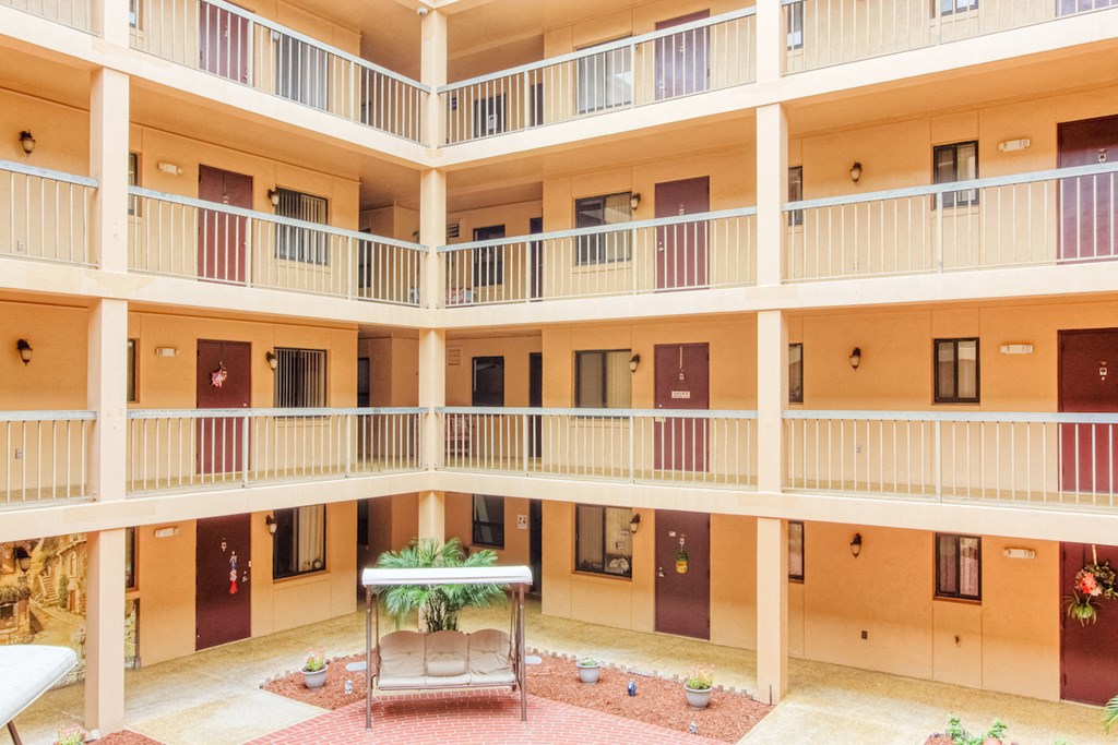 balconies with residential doors looking out over courtyard patio