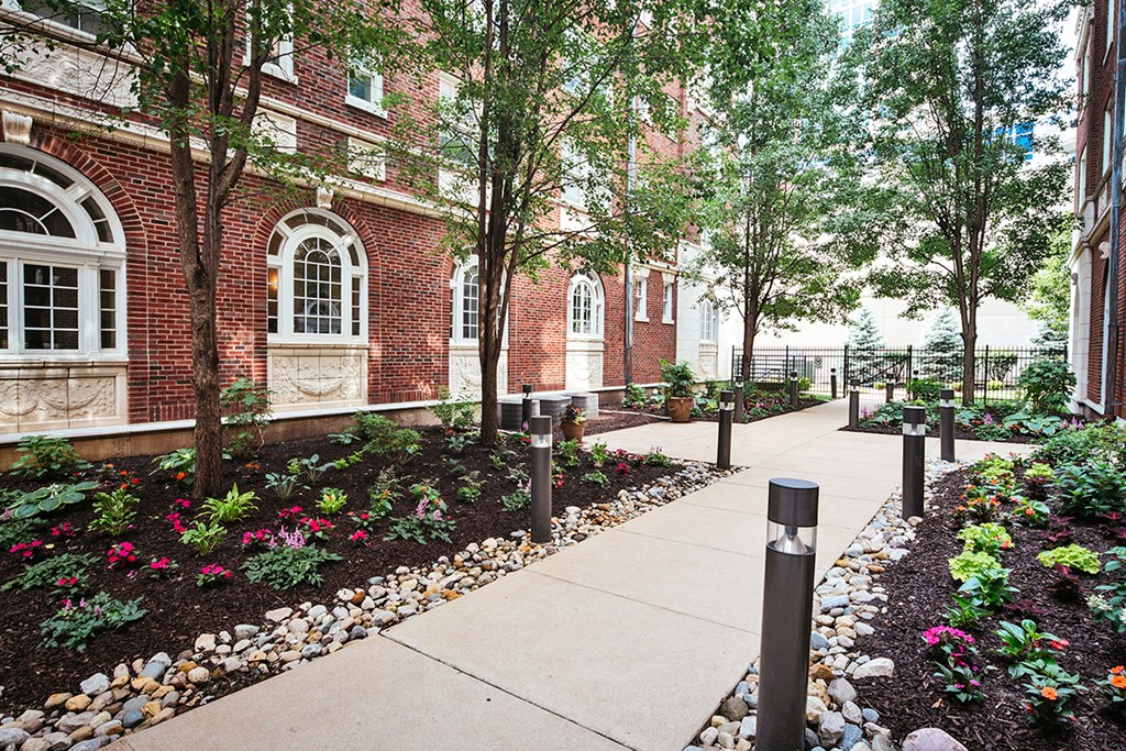 exterior sidewalk lined with trees at Residences at Forest Park, Saint Louis