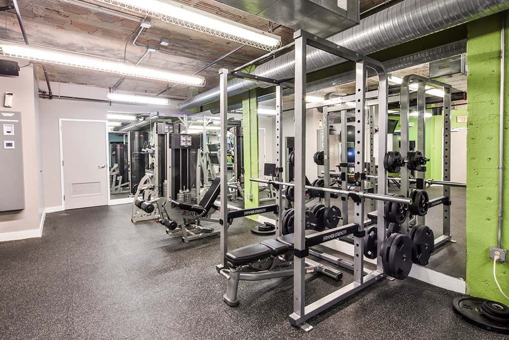 fitness center with dark flooring and weight lifting equipment at Residences at Forest Park, Saint Louis