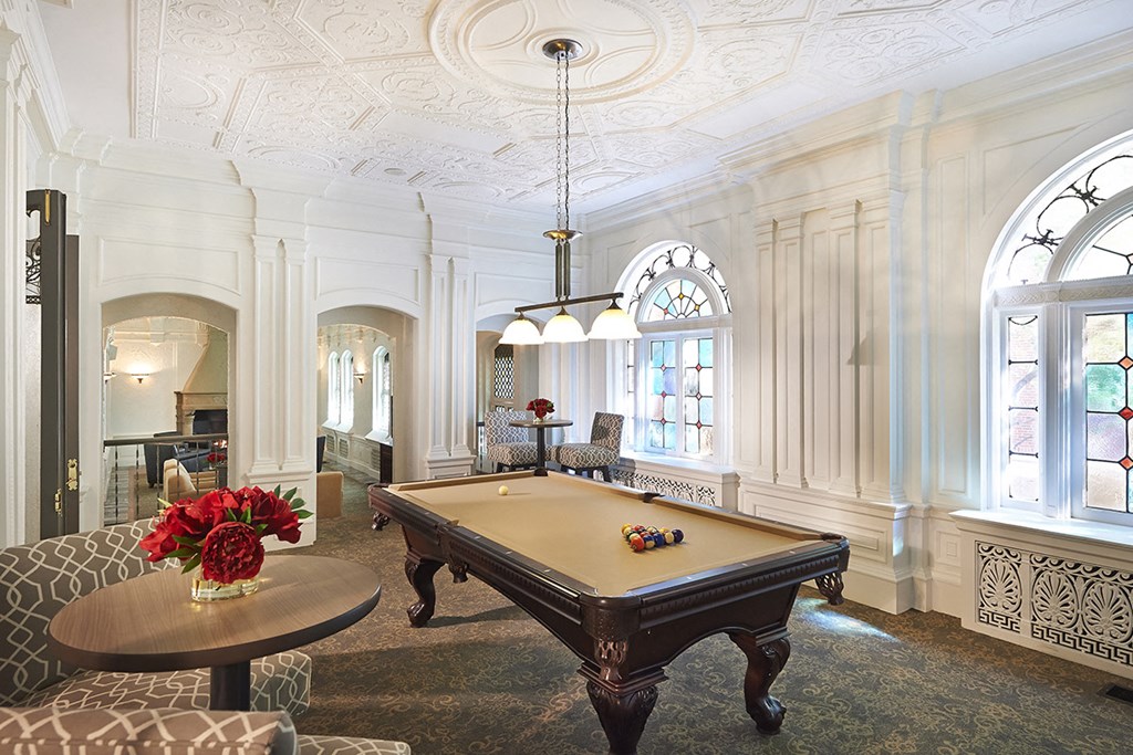 white room with pool table in center at Residences at Forest Park, Saint Louis, MO