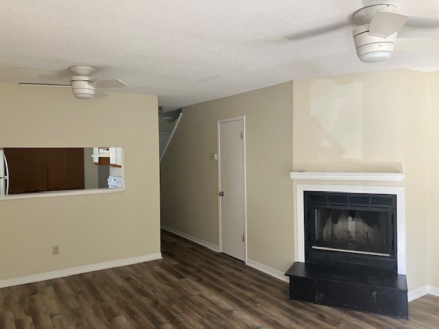 A room with a fireplace and a ceiling fan.
