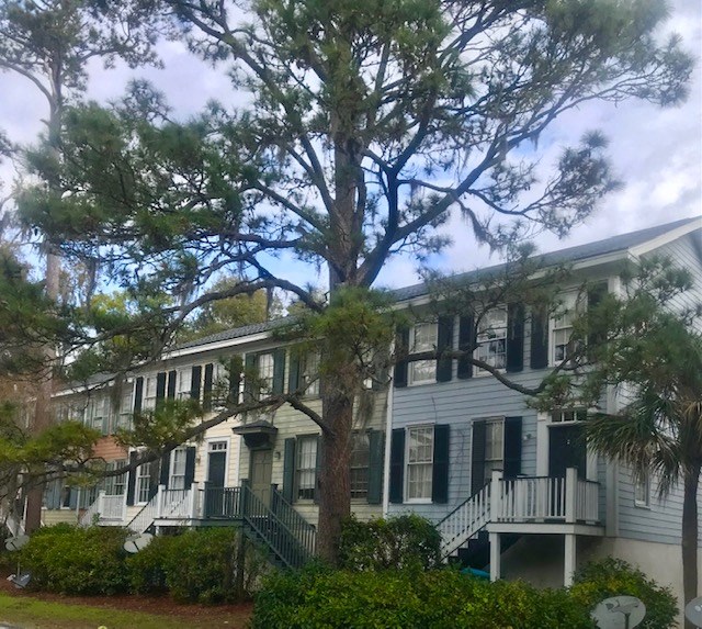 a large white house with trees in front of it