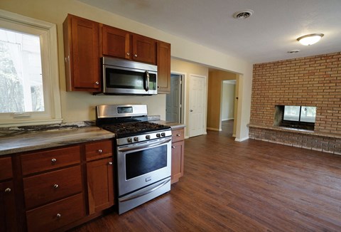 A kitchen with a stove top oven and microwave.