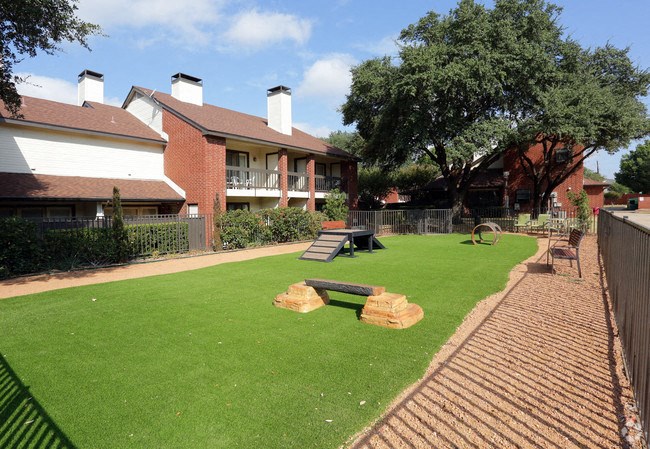a yard with benches in front of a house