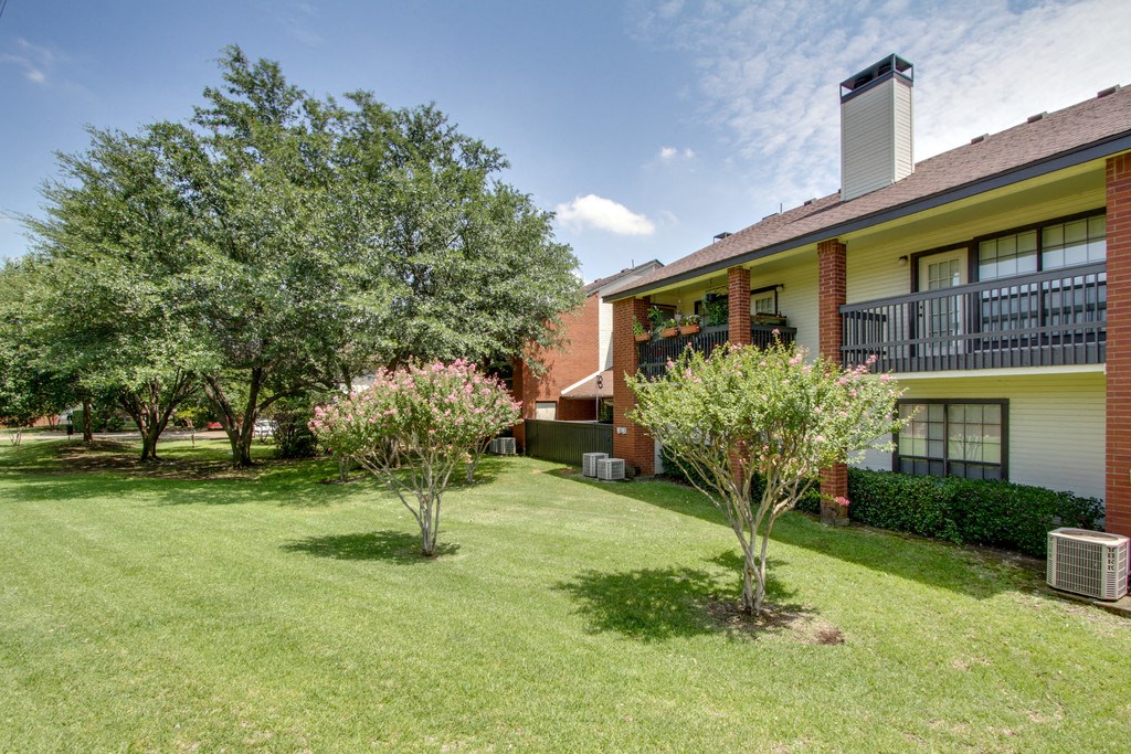 our apartments offer a green lawn and trees in front of our building