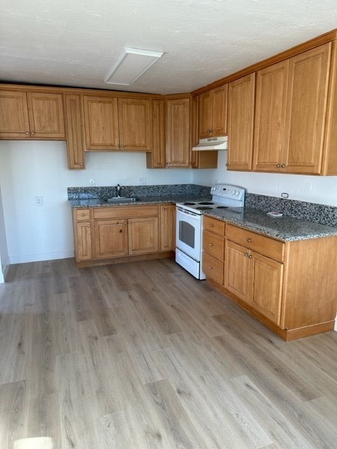 a kitchen with wooden cabinets and marble counter tops