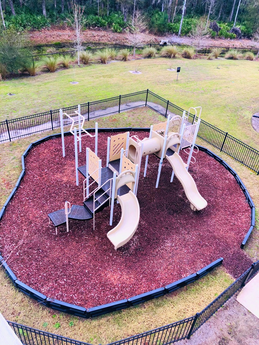 a playground with slides and chairs in a park