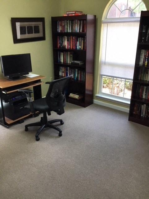 a office with a computer desk and a chair
