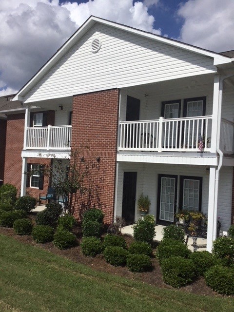 a white house with a porch and a balcony