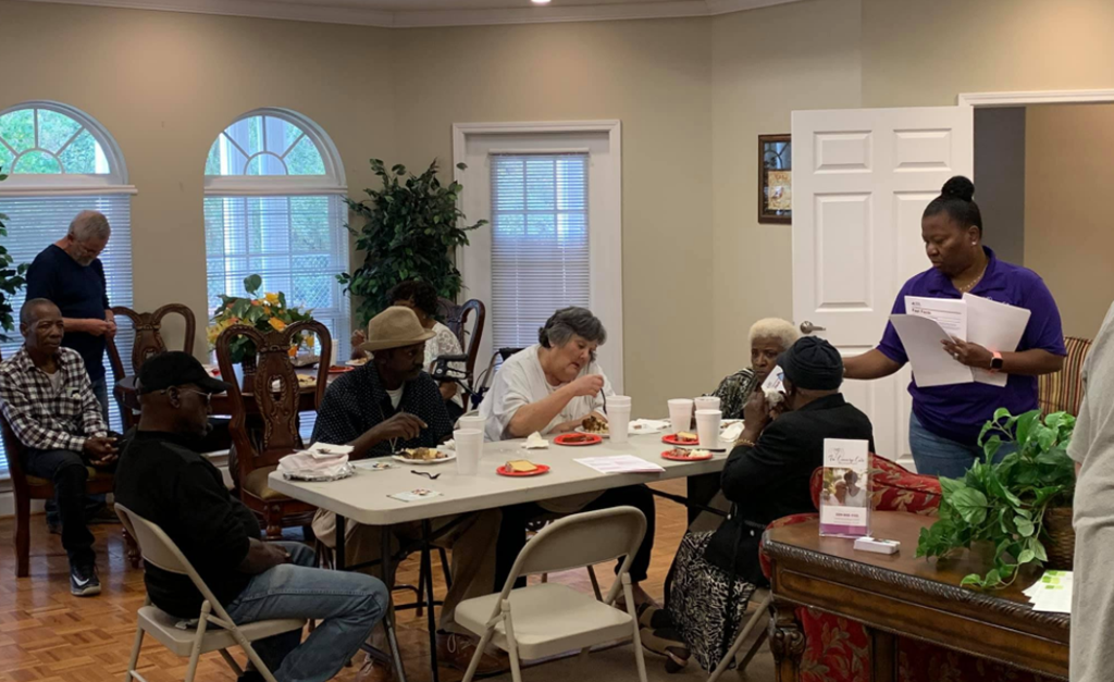 a group of people sitting around a table eating food