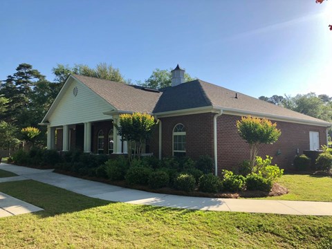 the front of a brick house with a sidewalk