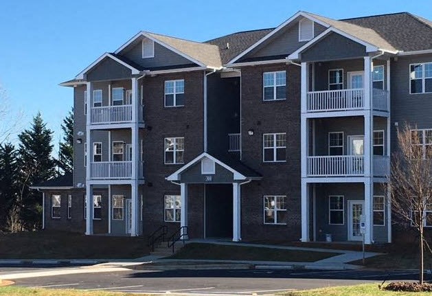 a large brick apartment building with balconies