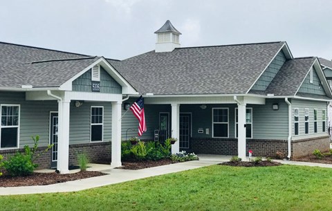 A building with a grey roof and a flag on the front.