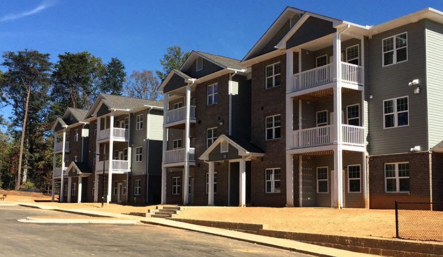 a row of apartment buildings on the side of a street