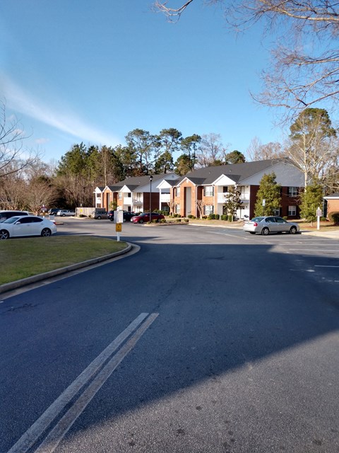 a street in a neighborhood with houses and cars