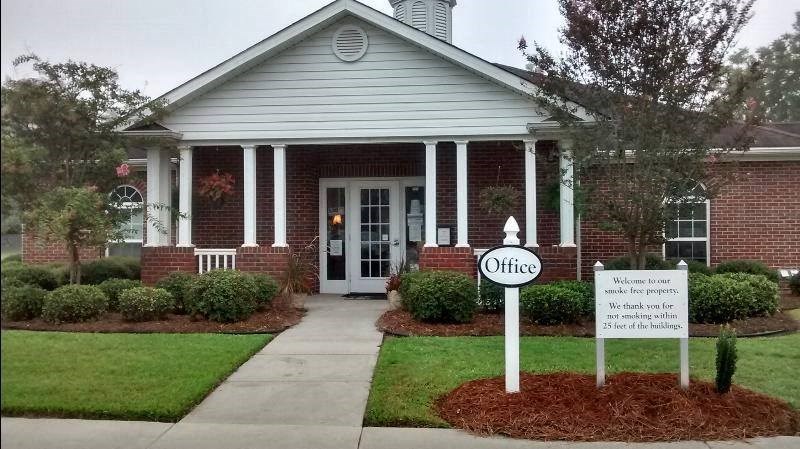a church with a sign in front of a house