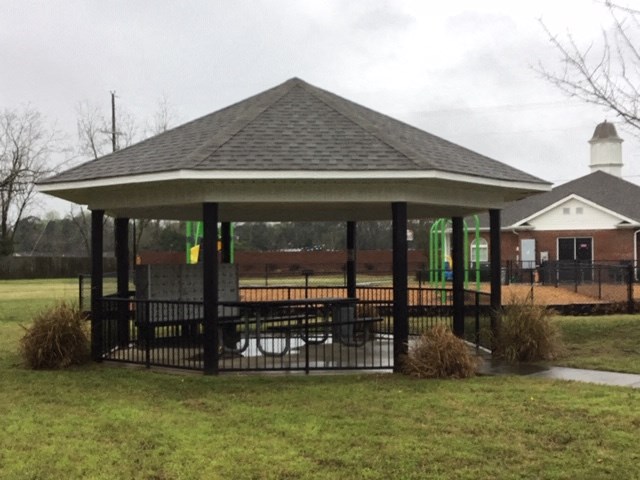 a gazebo with a wheelchair ramp in a yard