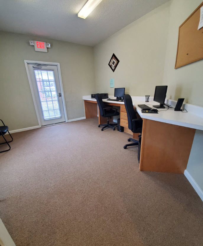 an office with two desks and two computers