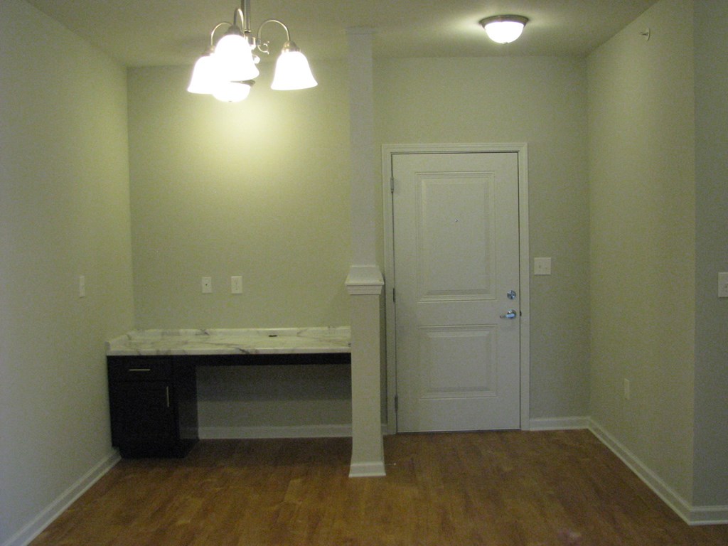 an empty room with a desk and a door