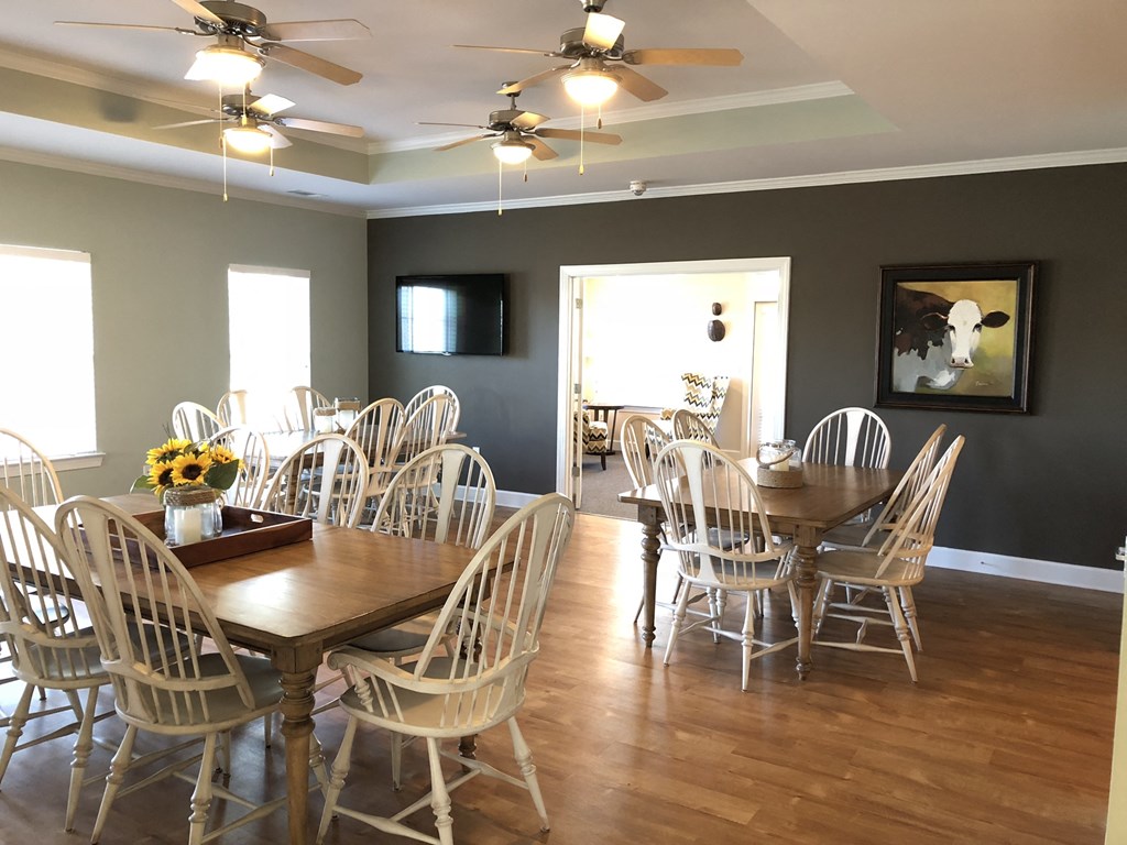 a dining room with a table and chairs and a tv