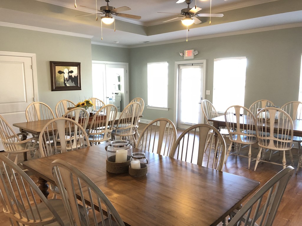 a large dining room with wooden tables and chairs