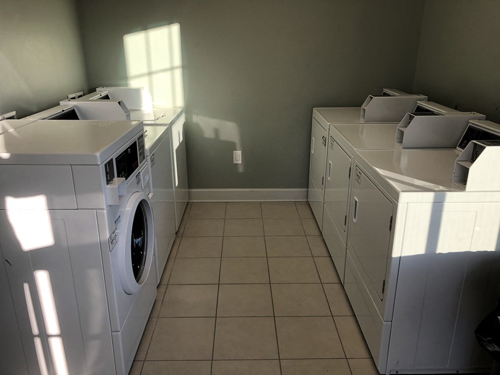 a laundry room with two washes and two dryers in it