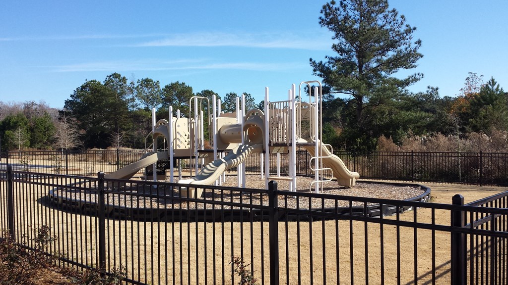 a playground with slides and other toys in a park