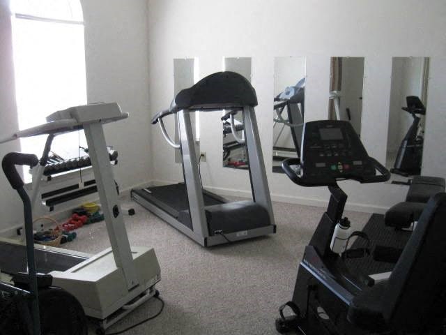 a gym with various pieces of exercise equipment