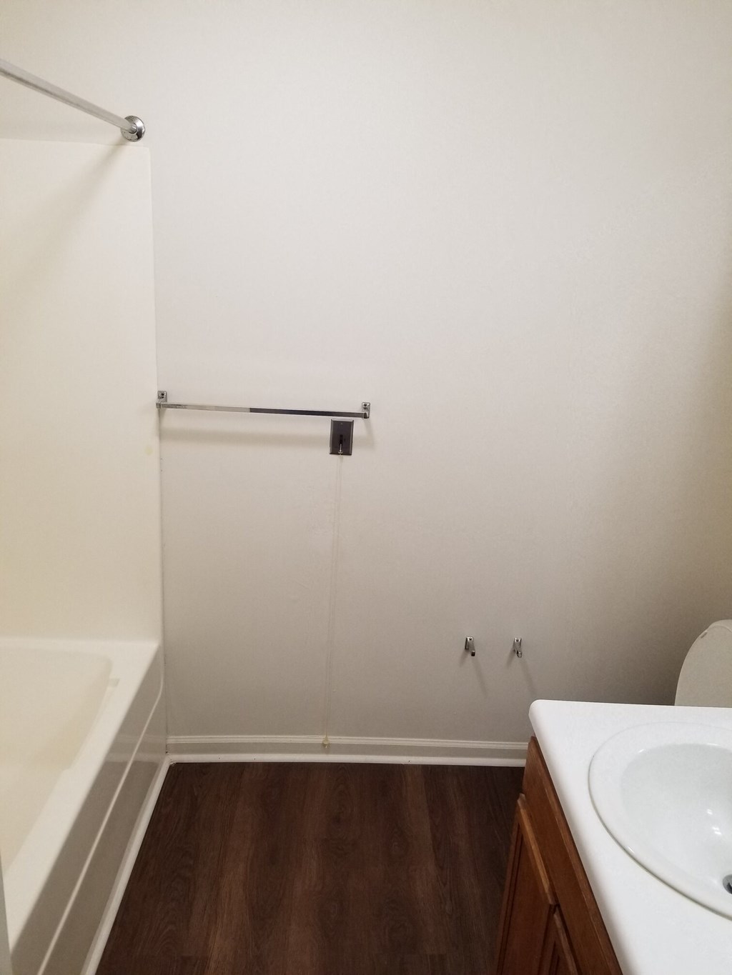 a bathroom with a sink and a bath tub and a shower curtain