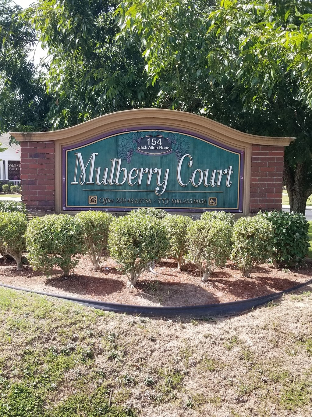 a sign for mulberry court in front of a building