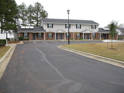 A building with a parking lot in front of it.