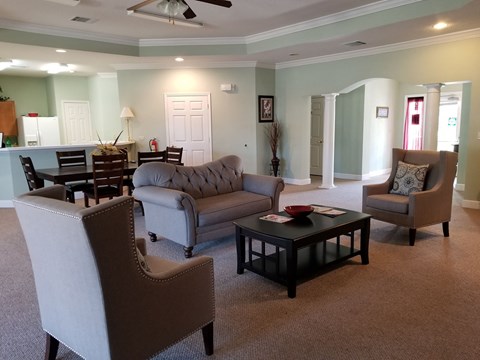 a living room with couches and chairs and a table
