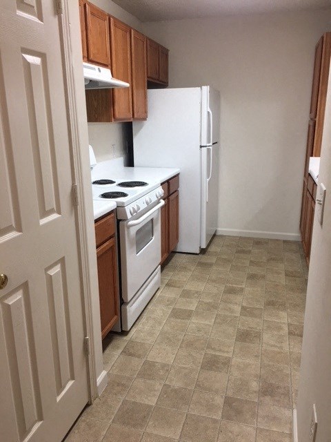 a kitchen with a stove and a refrigerator