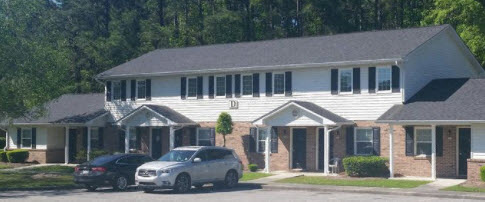 a house with two cars parked in front of it