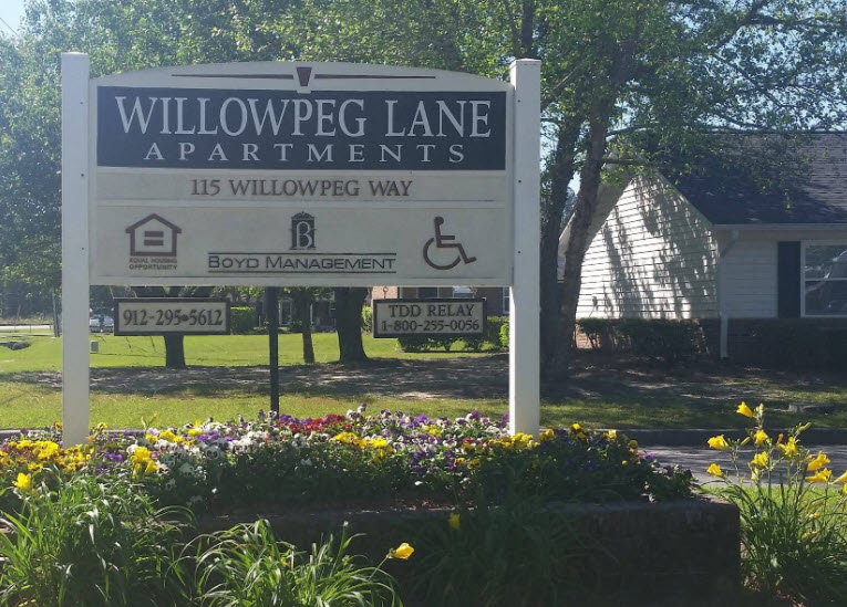 a sign apartments in front of a house